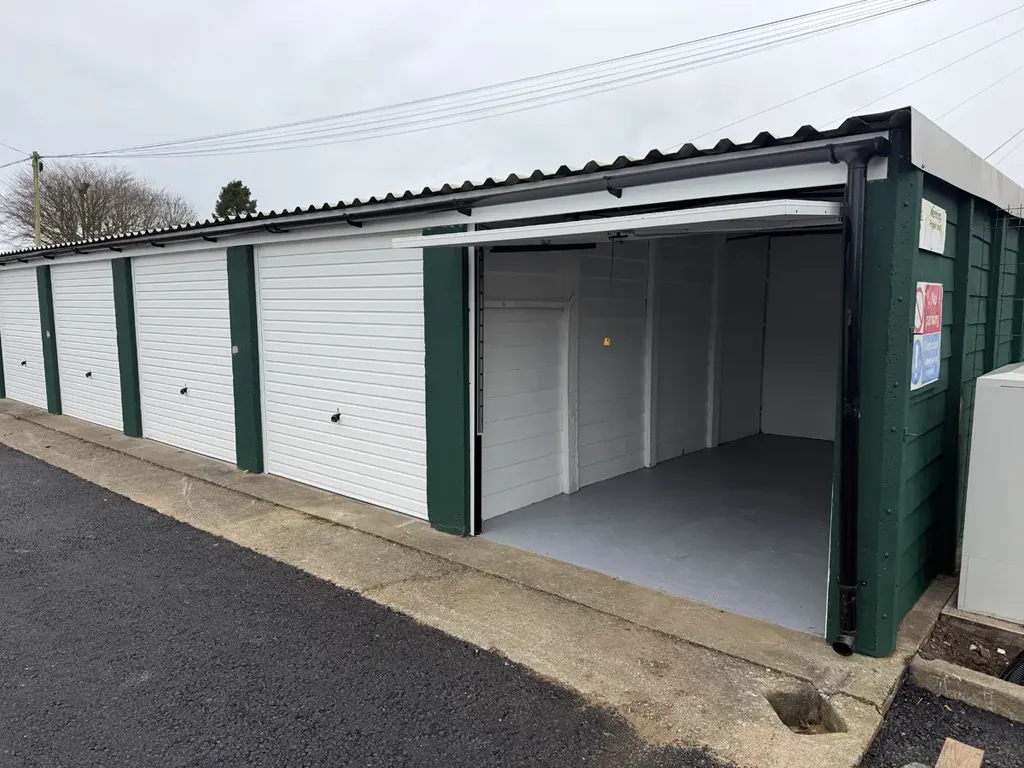 Open double garage interior at The Storage Containers Sherborne lock-up site, Wingfield Road, DT9 3HH — freshly refurbished with new white roller doors